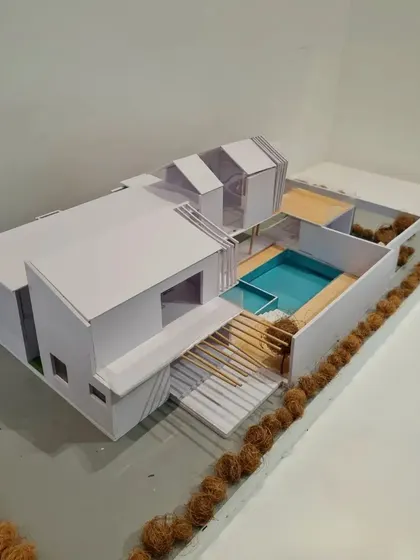 An architectural model for a farmhouse project in Kanakapura. Models like this help us and our clients visualize the spaces, including the A-line roof, central courtyard, and swimming pool.
