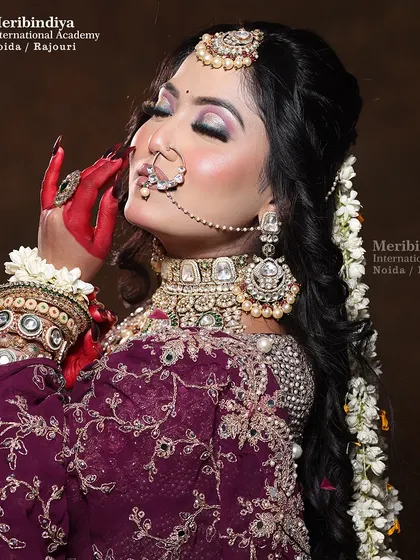 A close-up portrait focusing on the bride's expression and the beautiful way the 'gajra' is woven into her hair.