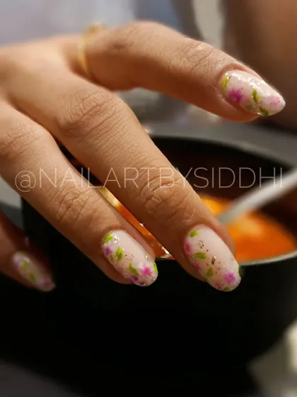 A delicate floral design with tiny pink flowers and green leaves on a sheer, shimmery base.