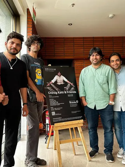 Posing with the band next to our concert poster in Bangalore. It's always a proud moment to see our names up for a big show.