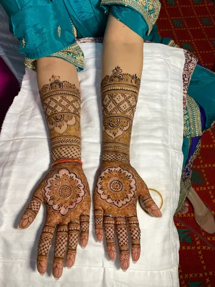 A clear top-down view of the full Rajasthani design, showing the matching patterns on both hands.