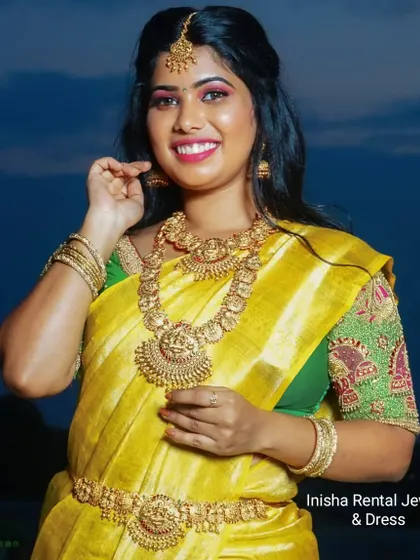 A bright and happy shot of a model wearing our full temple jewellery set. The matching pieces create a perfectly coordinated bridal look.