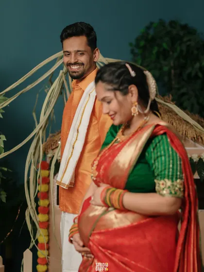 A candid shot of the couple sharing a happy moment during their traditional maternity session.