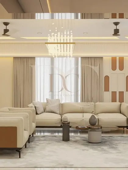 This view showcases the seating area, featuring a large L-shaped sofa and a contrasting green chaise lounge. The wall paneling with arched cutouts adds a unique decorative element, tying the whole room together.