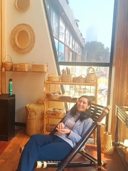 A customer relaxes in our bamboo recliner chair at our experience studio. This foldable and portable chair is perfect for gardens, balconies, or farmhouses, offering a comfortable way to enjoy the outdoors.