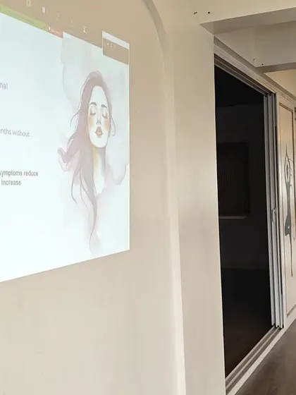 An expert leads a presentation during the Menopause Workshop, explaining the physiological and emotional changes and how yoga can provide holistic support.