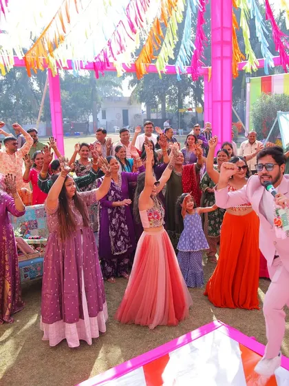 Leading the crowd in a dance step during a daytime Mehendi party. I make sure everyone, young and old, joins in the fun.