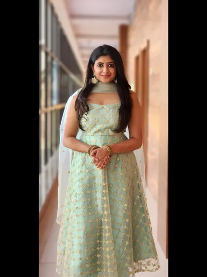 A full-length view of the pastel green anarkali, showing its graceful flow.