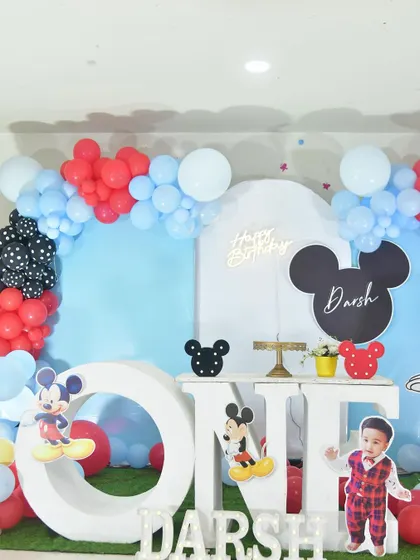 A closer view of the Mickey Mouse stage, featuring a large 'ONE' prop for photos.
