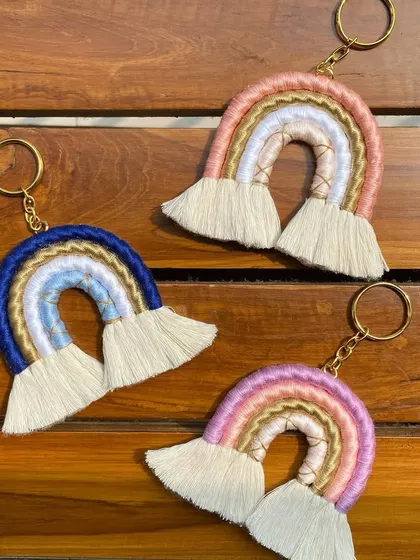 Three of our custom-colored macrame rainbow keychains displayed together. You can see the variety of color palettes we can create to match your event's theme.
