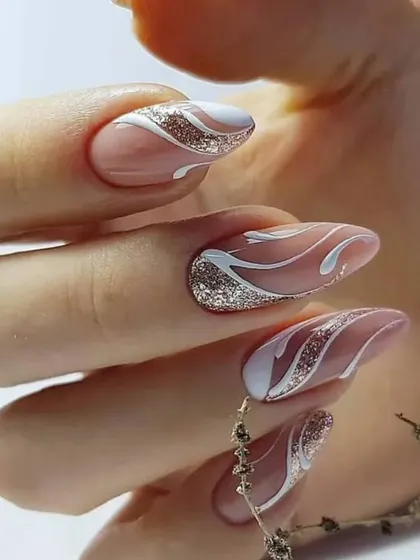 An elegant and sophisticated design with a nude base, white swirls, and sparkling silver glitter accents.