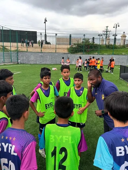 Coaches giving a halftime talk to the U13 team during their TAL match.