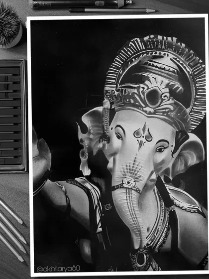 A close-up charcoal drawing of Ganapati Bappa on A4 paper. The focus on his face and trunk highlights the fine details and textures, showing a different perspective of the deity.