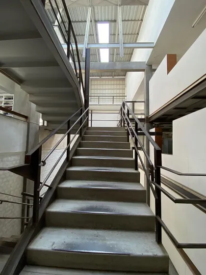 Looking up the main staircase at Zanav Home. The combination of heavy concrete treads and a light steel structure is a hallmark of our approach.