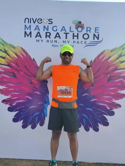 One of our runners posing with the iconic wings at the Mangalore Marathon. Race trips are a chance to explore new places and make memories.