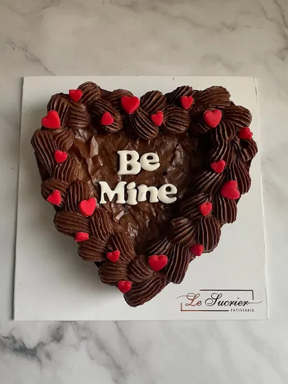 Your perfect Valentine's gift is just an order away. This heart-shaped Belgian chocolate brownie is topped with rich chocolate ganache and a "Be Mine" message.