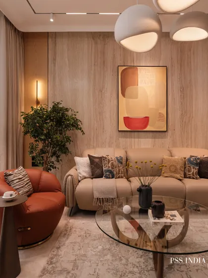 A living room designed for connection and conversation. I used sculptural forms, like the curved leather armchair and unique coffee table, to add personality. The warm wood walls and layered textiles ensure the modern aesthetic still feels cozy and inviting.