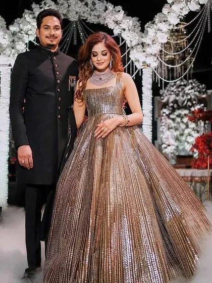 A metallic, pleated ballgown makes for an unforgettable reception look. I can design a similar structured gown that combines modern texture with classic glamour.