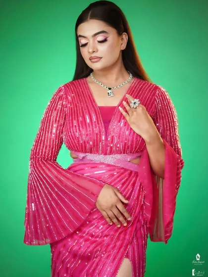 The green background makes the pink outfit pop, a concept we discuss in our social media marketing session.