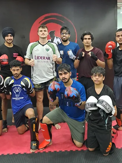 The Muay Thai crew after a session with their coach, showcasing the results of hard work and dedication.