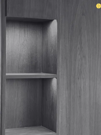 A close-up of a built-in shelf, showcasing the beautiful grain of the wood veneer. This is an example of the quiet, obsessive detailing that goes into every project.