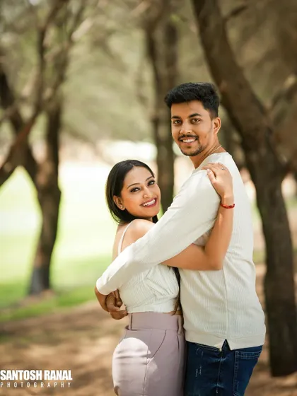 A warm and loving embrace captured in a natural, outdoor setting.