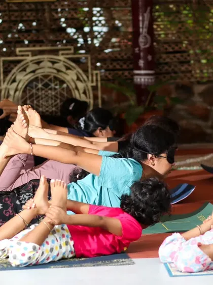 It's a joy to see participants of all ages practicing yoga together. Here, a group including children engages in Dhanurasana (Bow Pose) during our family-friendly Atmarpan Retreat, showing that yoga is for everyone.