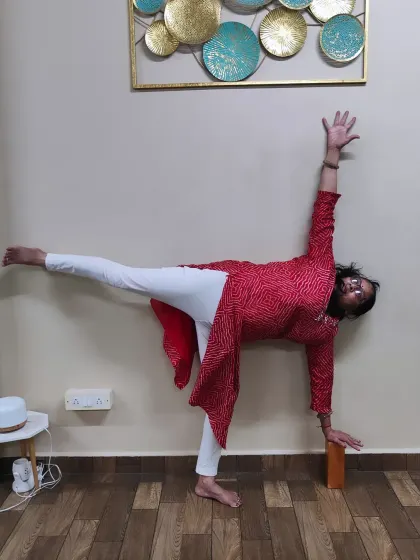 Age is truly just a number. Here is one of my students, over 60 years old, gracefully holding Ardha Chandrasana (Half Moon Pose) with block support. My classes for seniors are designed to build strength and improve mobility safely.