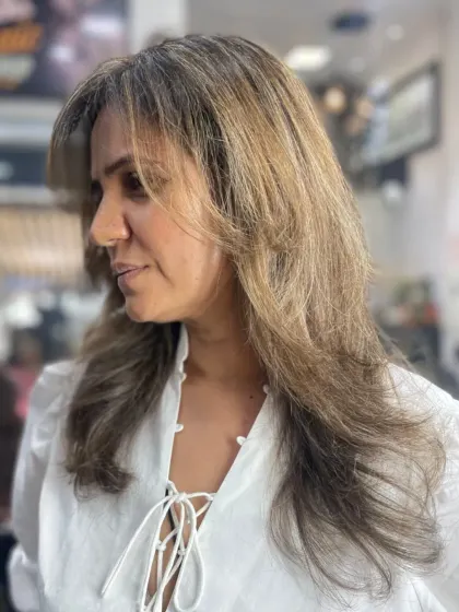 A soft, layered haircut that frames the face beautifully. This is a versatile and flattering style for medium to long hair.