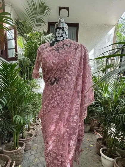 The full view of the powder pink saree, showing its graceful and flowing silhouette. It’s a perfect outfit for a sundowner or a day wedding.