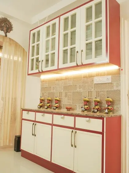 A traditional crockery unit with a red and white color scheme and glass-front cabinets. This piece adds a classic touch to the dining area while providing ample storage.