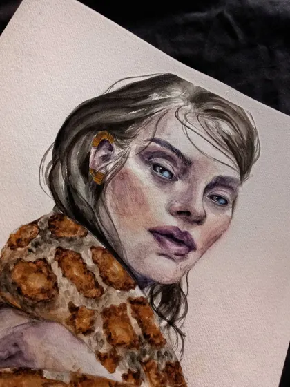 An angled view of the finished watercolor painting, showing how the light catches the paper.