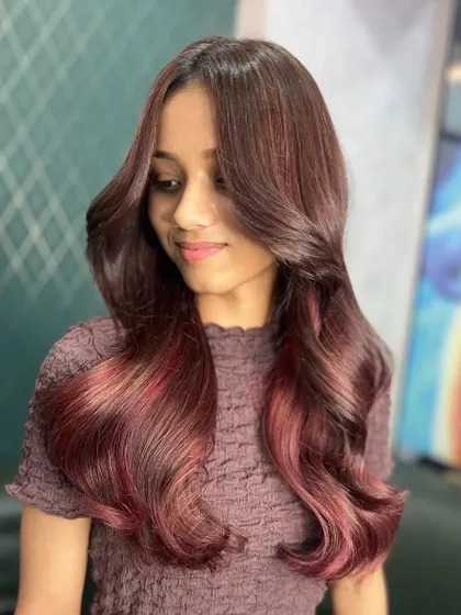 Another angle of the stunning red hues. The color is rich and dimensional, giving her a look that is both bold and sophisticated.
