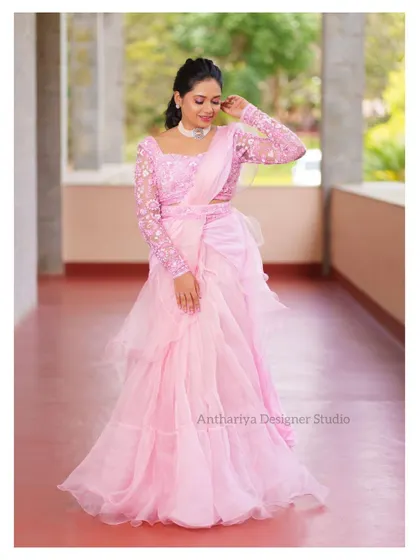 A full-length view of the pink ruffled saree-lehenga, showing its unique and fashionable silhouette.