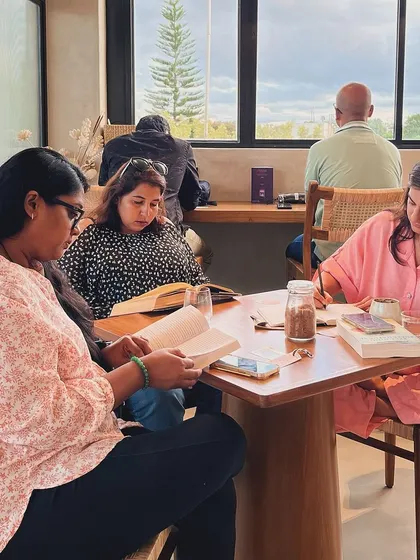 A table of readers, each lost in their own world, together. This is the simple magic of our weekly reading socials.