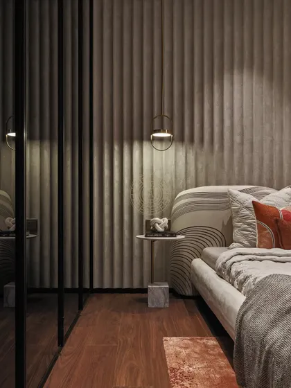 A detail of the textured wall paneling and bedside lighting. The soft, vertical lines of the wall add a sense of height and elegance, while the simple pendant provides focused light for reading.