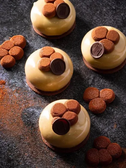 An artistic overhead shot of individual patisserie items. This minimalist and modern composition is ideal for showcasing the artistry of a pastry chef.