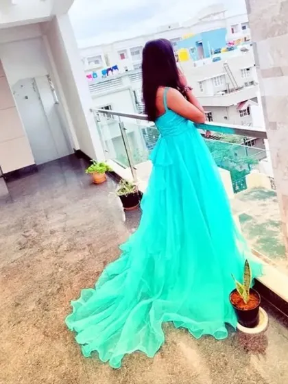The back view of this turquoise trail gown shows off its length and beautiful movement.