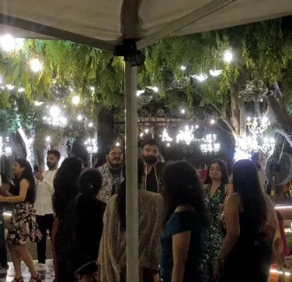 An outdoor wedding with beautiful lighting and a happy crowd.