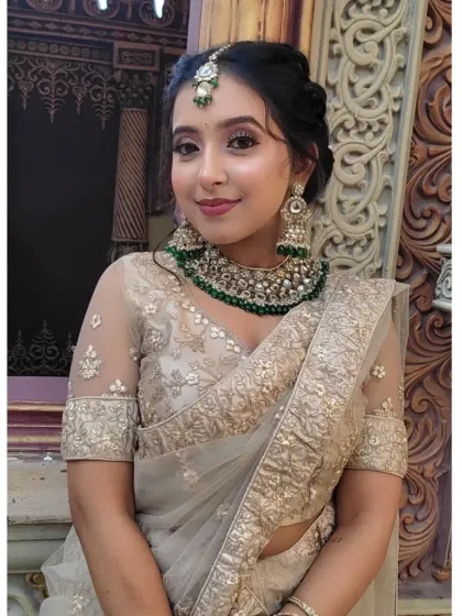 This is an example of a more glamorous look suitable for a reception or sangeet. It features defined eyes, sculpted features, and a bold lip, showing how we can dial up the drama for an evening event.
