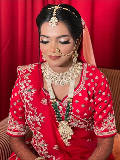 A serene portrait of the bride, looking down and showing off her beautiful eye makeup.