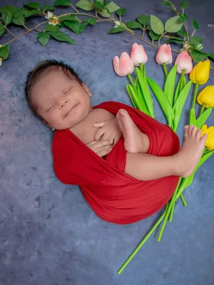 A smiling dreamer. Even in their sleep, this baby's happy expression shines through, all while being safely swaddled.