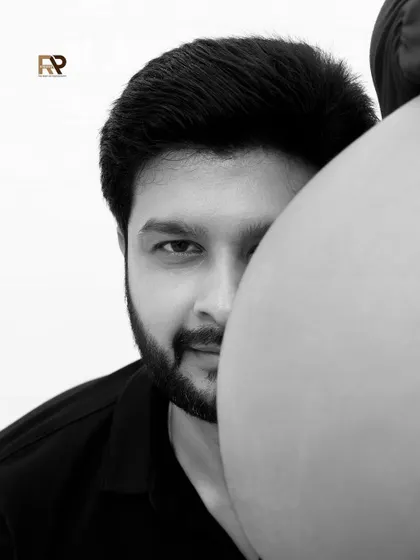 A peek into the future. This creative shot with the dad-to-be peeking from behind the baby bump is a playful and artistic way to capture the anticipation of fatherhood.