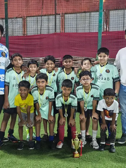 Our U11 champions posing with their coaches after winning the Andheri Premier League.