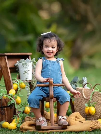 Look at that happy smile! Themed outdoor sessions are a fantastic way to capture the joyful spirit of toddlers.