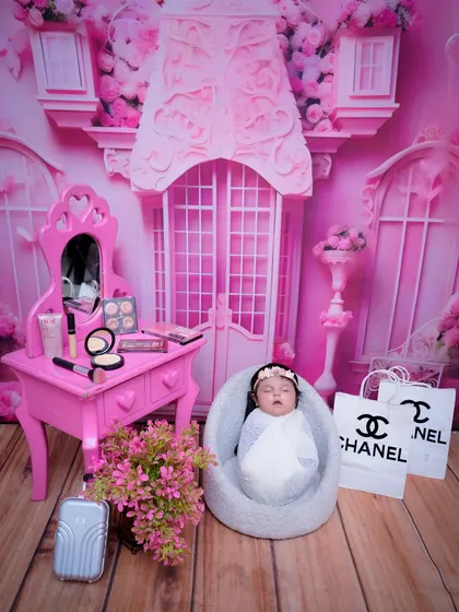 Another angle of the pink, fashion-inspired newborn setup, providing a full view of the elaborate and charming props.