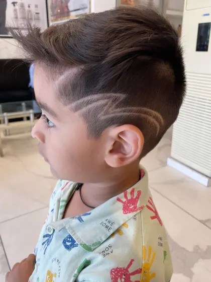 Haircuts for kids should be fun and stylish. We created this cool lightning bolt design with a sharp fade for one of our youngest clients, showing that great style has no age limit.