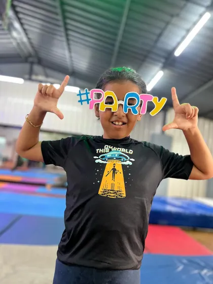 Framing the party. This student's creative pose and big smile are infectious.