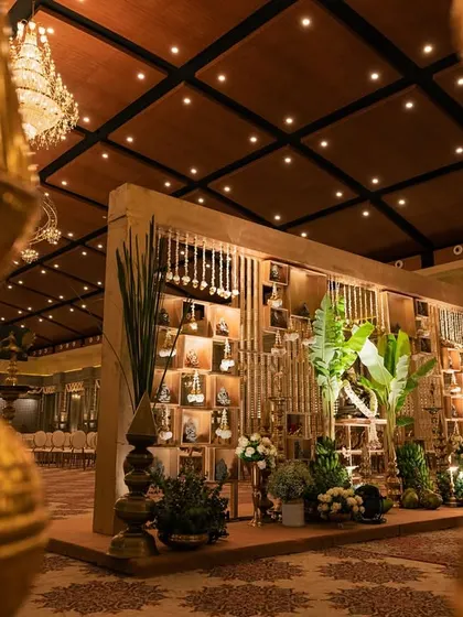 A shot of the elegant and rustic wedding decor, featuring a wooden backdrop and traditional brass lamps.