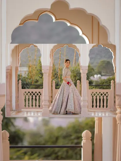 A creative bridal portrait using the palace arches at Jaibagh Palace to frame the shot.